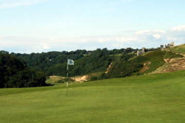 Pennard Golf Club overlooks a valley and 12th-century castle ruins.