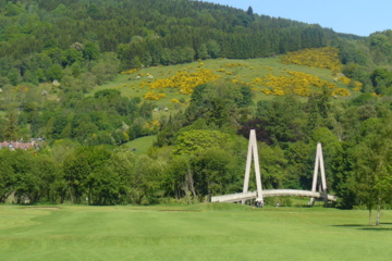 The approach on Aberfeldy Golf Club's fifth hole features the club's famous walking bridge behind the green.