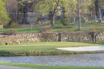 Garrison Golf Club's 14th green is surrounded by gravestones overhead on the hill.