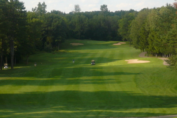 Timber Ridge Golf Club's 10th hole rolls out below you.