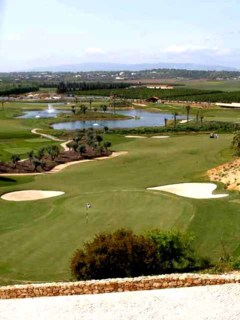 The Monchique Mountains serve as a backdrop to the O'Connor Course at Amendoeira Golf Resort in Portugal.