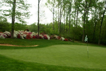 Flowers bloom behind the 10th green at Augustine Golf Club.