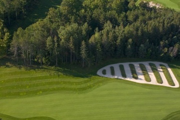 The opening hole at Wooden Sticks Golf Club features an Oakmont-inspired "church pew" bunker with an original hole design.