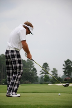 Keeping your weight predominantly behind the ball (notice the back heel) causes the body to spin or over-rotate and the club to come over the top.