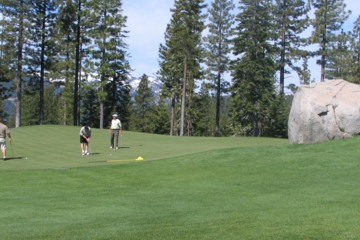 Golfers putt on No. 7 while Coyote Moon's Hooligan's Rock looms large (literally) in watch.