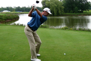 For more distance off the tee, Les Miller recommends keeping a light grip pressure throughout the swing.