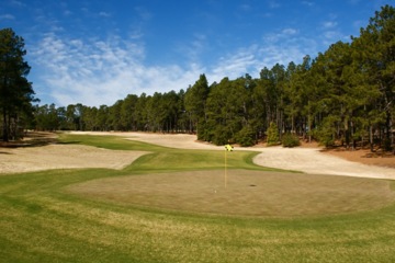 The par-5 second hole at Pinehurst No. 4 plays downhill to a green with runoff areas. 