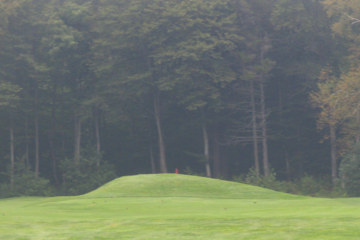The flag's but a glimpse of red over the hill on Saranac Inn's Par-3 seventh.

