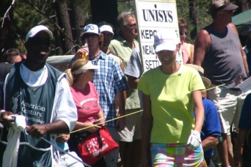 Ex-Trump star Carolyn Kepcher smiles through finish at a celebrity golf tournament.
