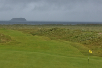 The view back from the 13th green on the Glashedy Links at Ballyliffin Golf Club includes Glashedy Rock off in the distance. 