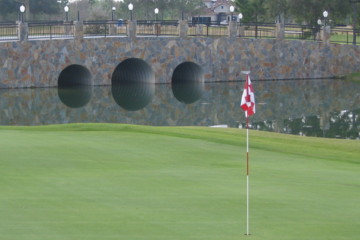 Pretty No. 17 features a pond and stone bridge to the right of the green.