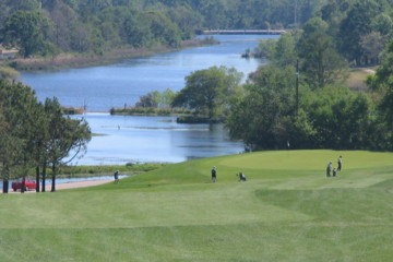 The 10th at Azalea City Golf Course plays downhill, with the city park's lagoon in the background.